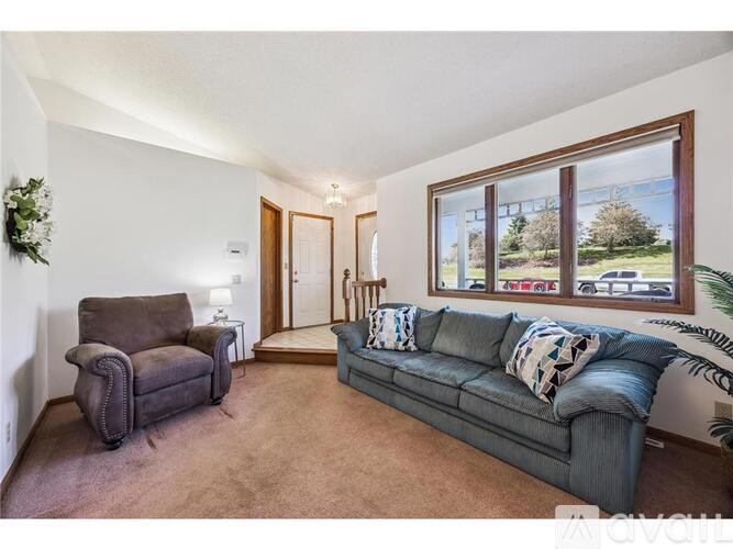 A living room with a grey couch and a brown armchair.