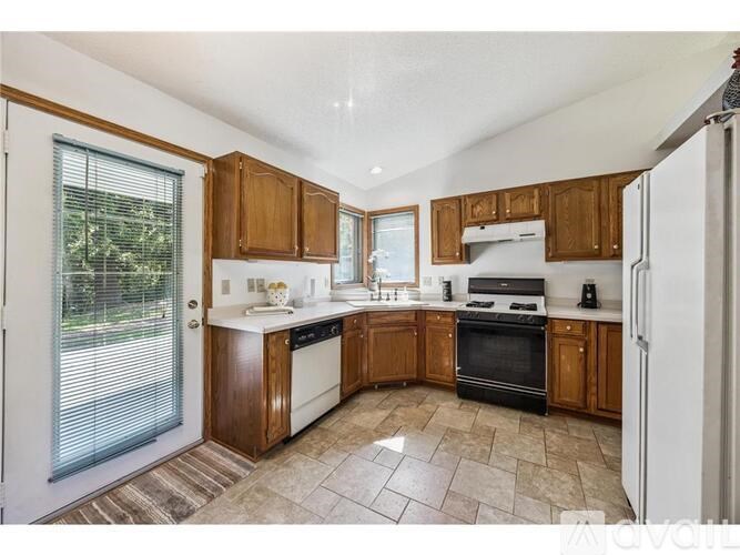 A kitchen with wooden cabinets and a black oven.
