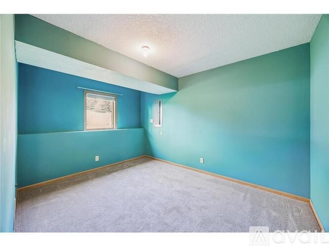 A room with blue walls and a window.