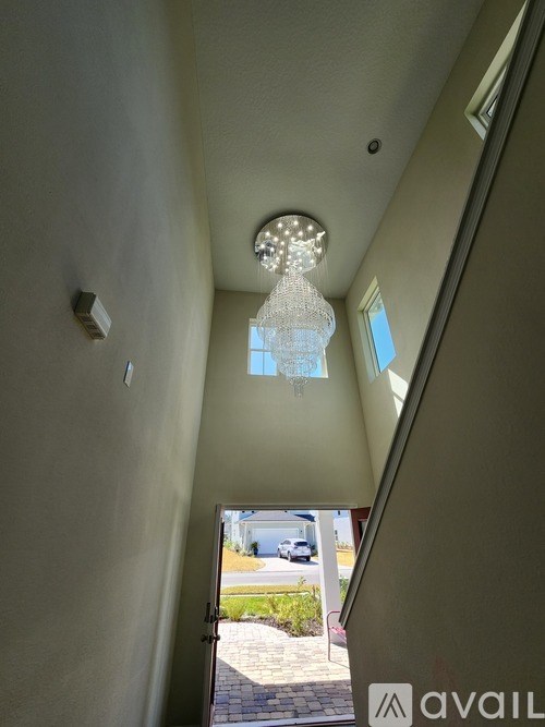 A hallway with a light on the ceiling and a window on the wall.