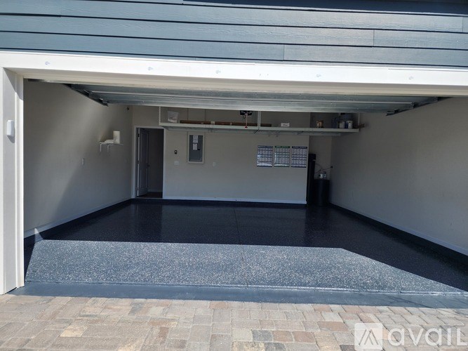 A garage with a black floor and a grey ceiling.