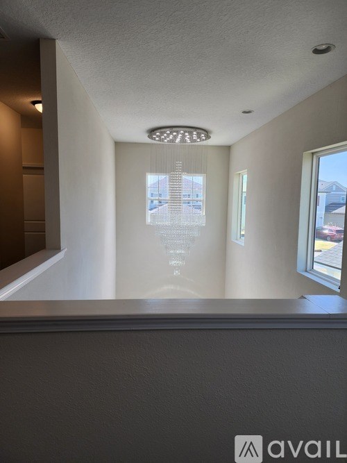 A room with a window and a ceiling light.