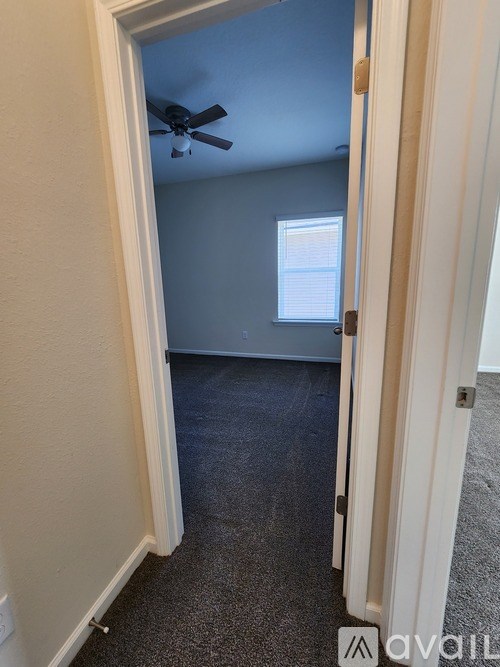 A room with a ceiling fan and a window.