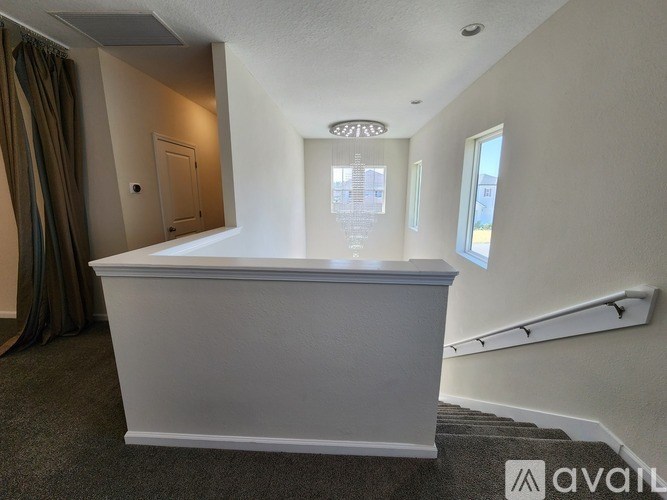 A white reception desk in a room with a window and a door.