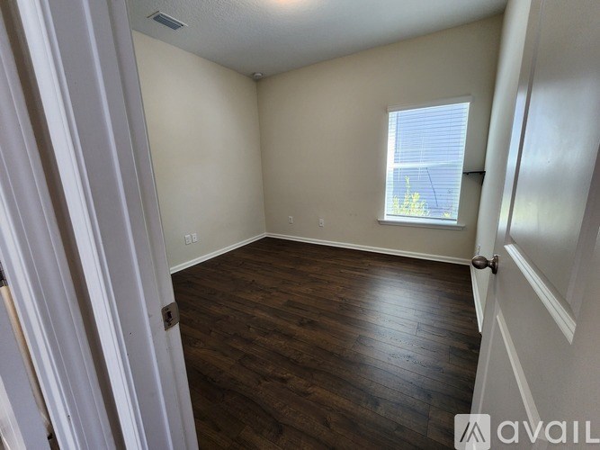 A room with wooden floors and white walls.