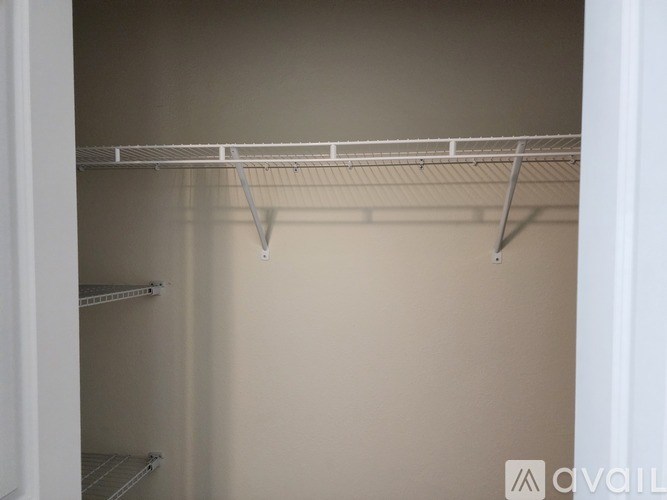 Empty white shelves in a room.