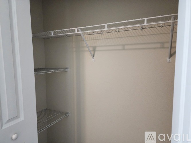 Empty white shelves in a pantry.