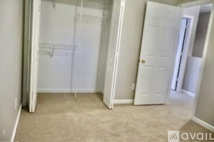 A room with a white door and a wall with musical notes drawn on it.