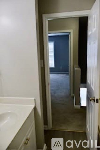 A bathroom with a white sink and a mirror.