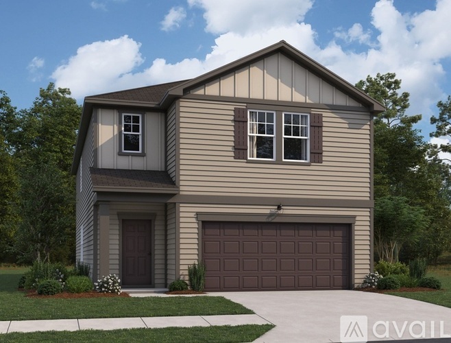 A two-story house with a garage is available for sale.
