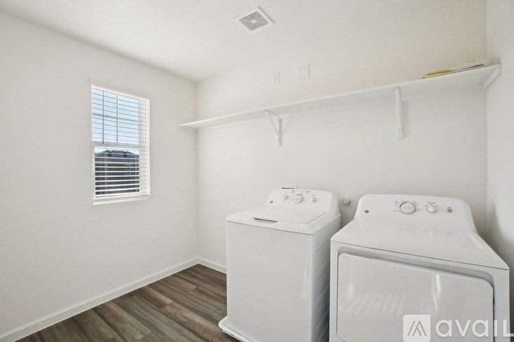 A small laundry room with a washer and dryer.