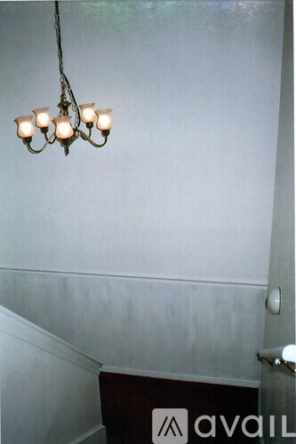 A chandelier with six lights hangs from the ceiling.