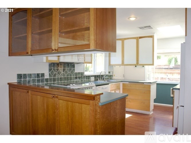A kitchen with wooden cabinets and a countertop.