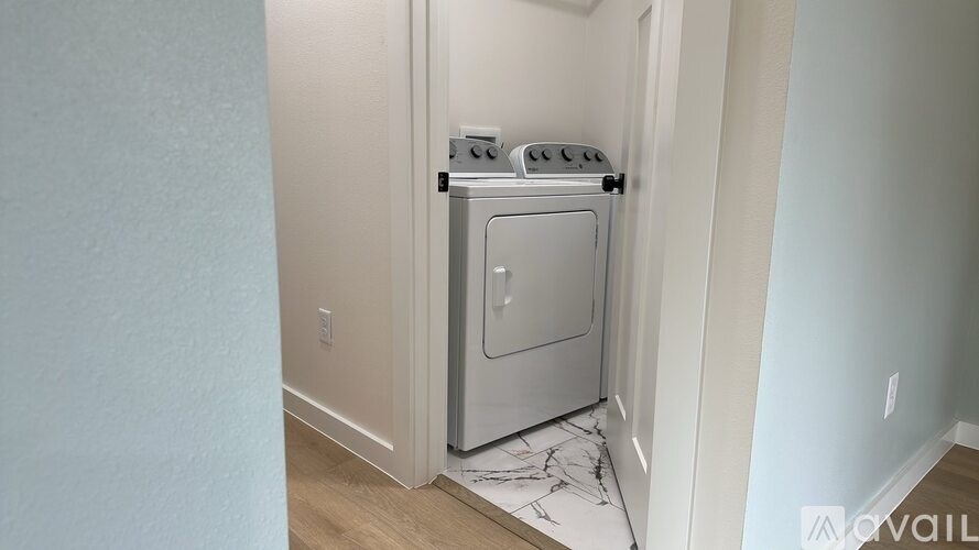 A small, white, built-in oven and microwave in a kitchen.