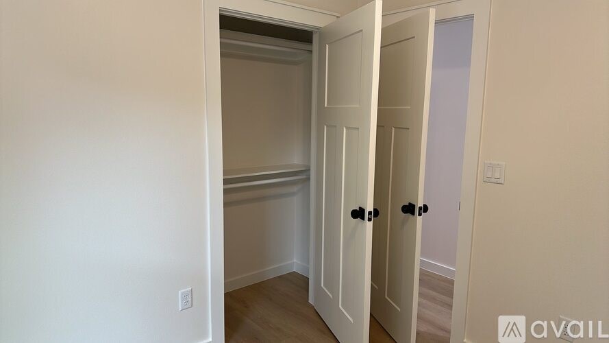 A room with a white door and a white wall.