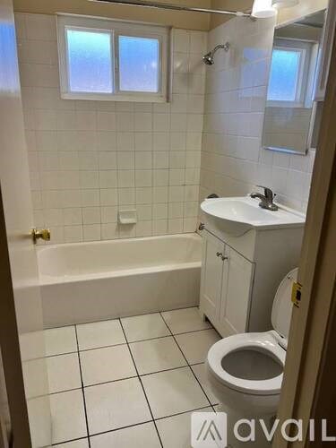 A bathroom with a toilet, sink, and bathtub.
