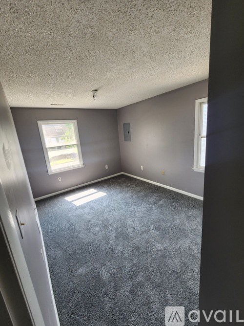 A room with grey walls and a window.