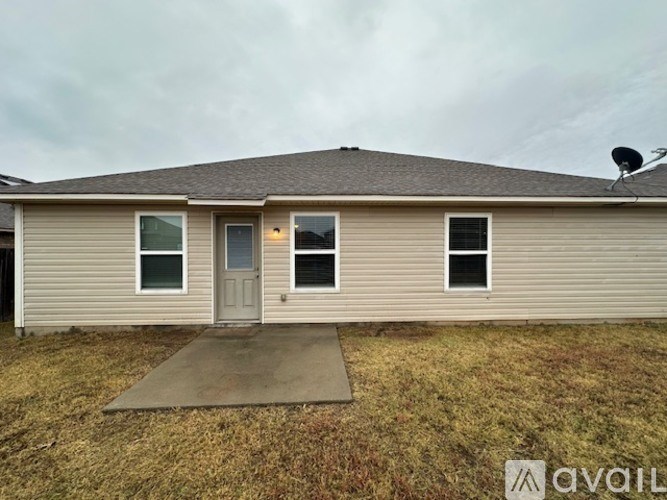 A house with a grey roof and a satellite dish on the roof.