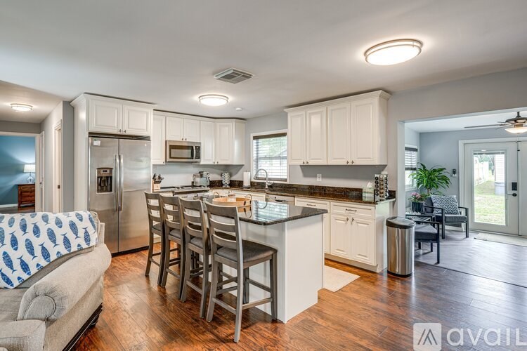 A kitchen with a dining table and chairs.