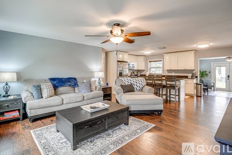 A living room with a grey couch and a coffee table.