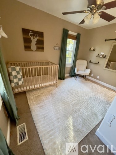 A baby room with a crib and a chair.