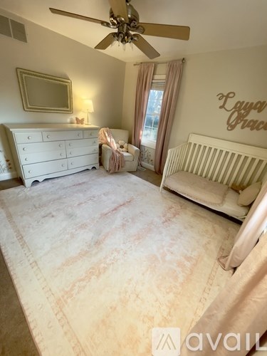 A baby's room with a white crib and a dresser.