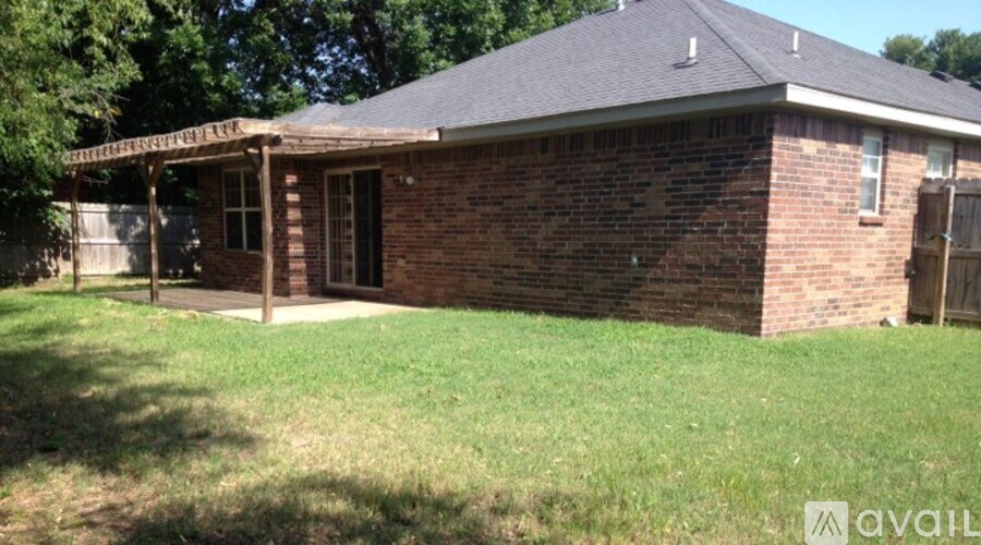 A brick house with a porch and a sign that says "available".