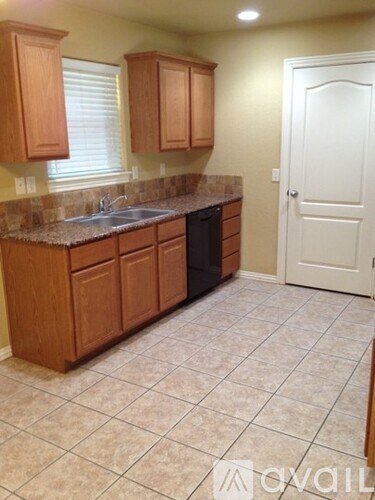 A kitchen with wooden cabinets and a white door.