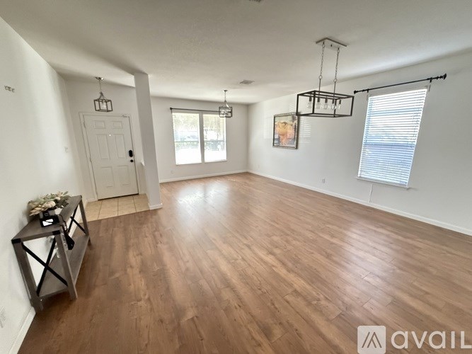 A room with wooden flooring and a white door.