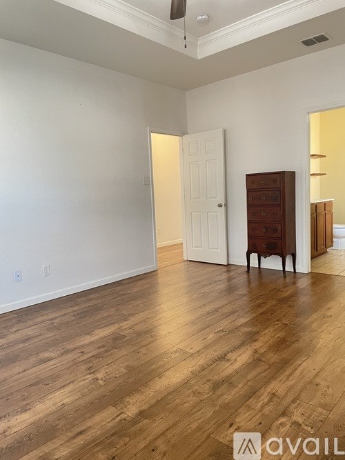 A room with wooden floors and white walls.
