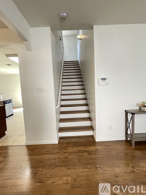 A staircase with a light switch on the wall.
