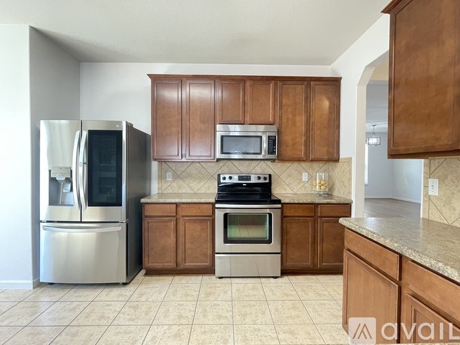 A kitchen with wooden cabinets and stainless steel appliances.
