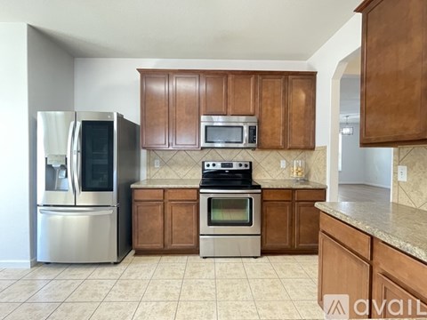 A kitchen with wooden cabinets and stainless steel appliances.