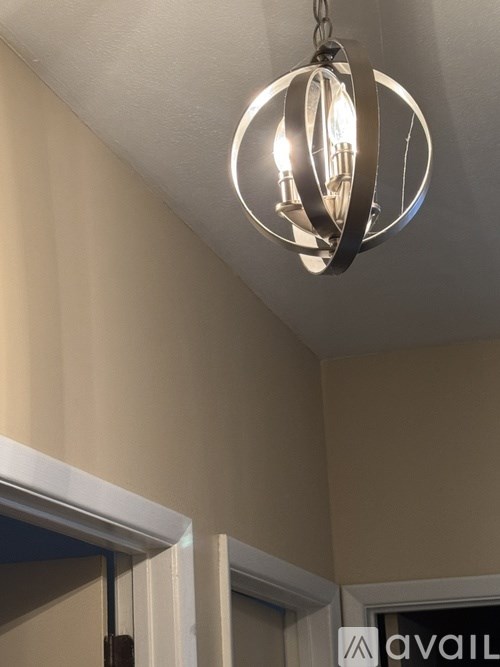 A chandelier with a circular design hangs from the ceiling.