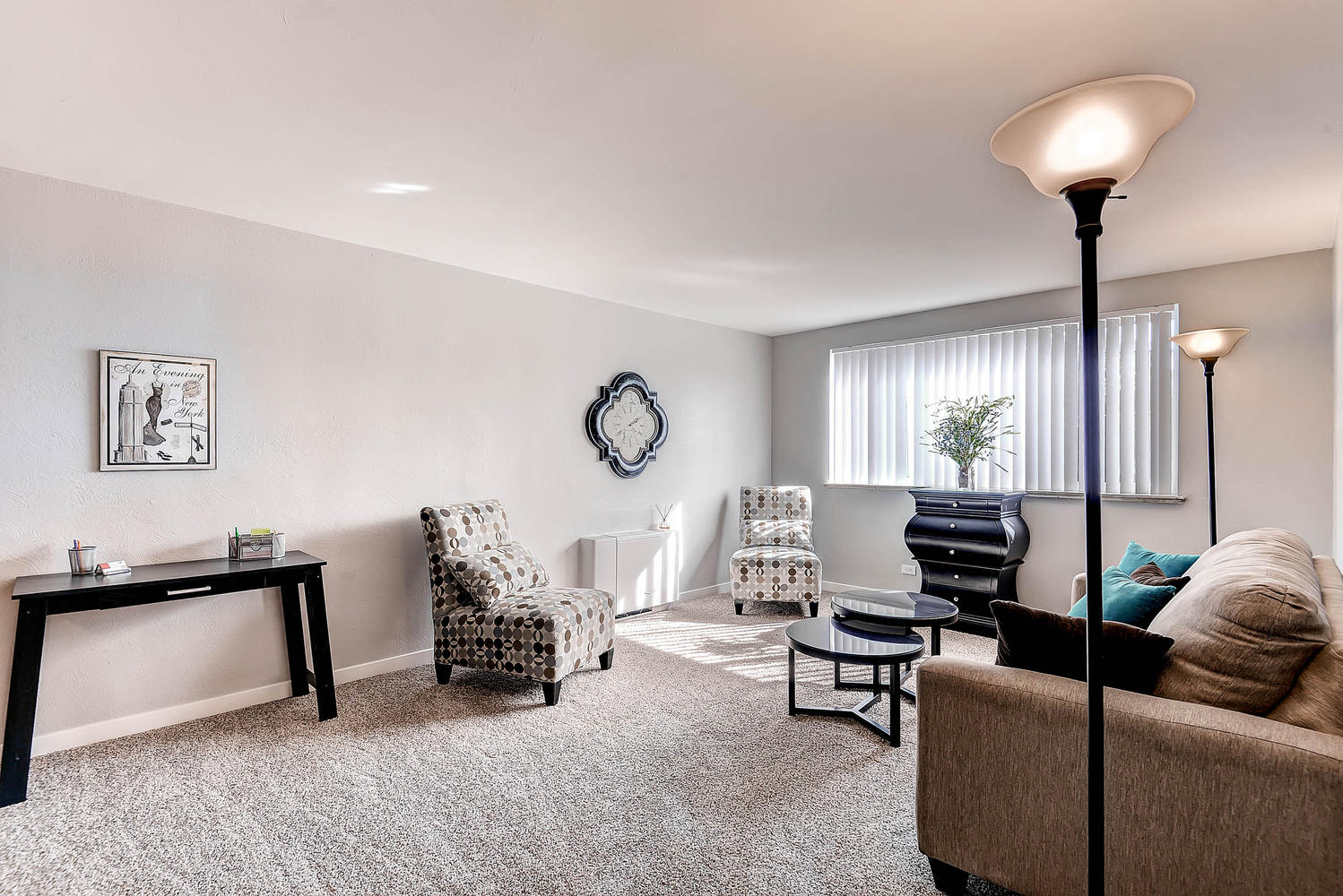 a living room with a couch and chairs and a table