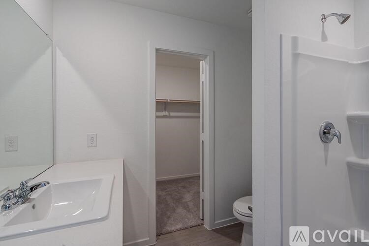 A bathroom with a white tub and toilet.