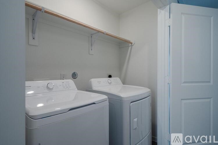 A small laundry room with a washer and dryer.