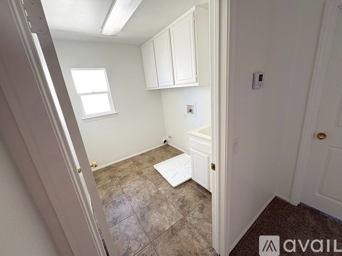 A small room with a tiled floor and a window.
