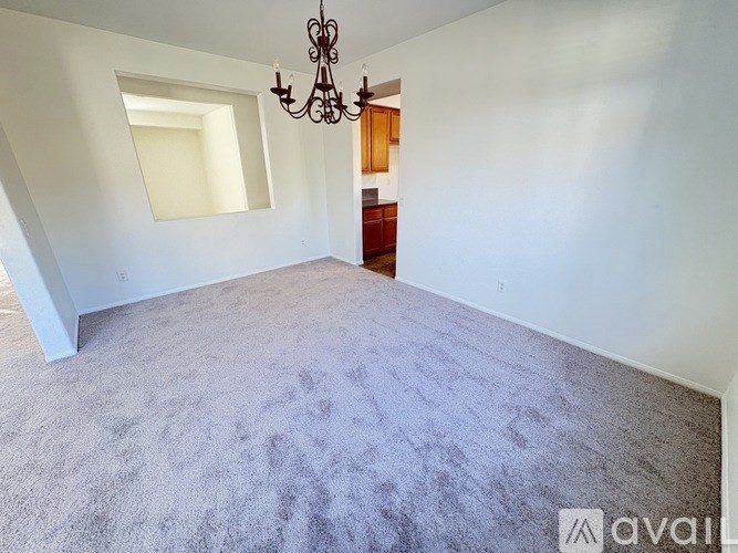 A room with a chandelier and a window.