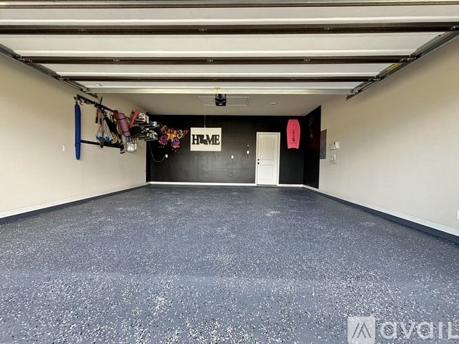 A sparsely furnished room with a sign that reads "HOME".