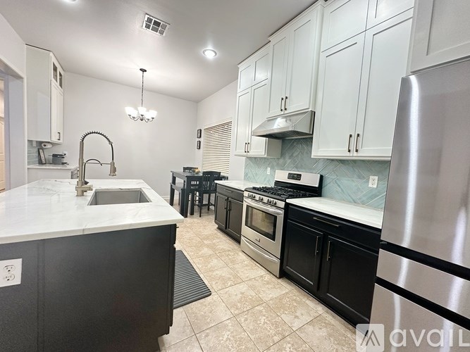 A kitchen with black cabinets and a white counter top.