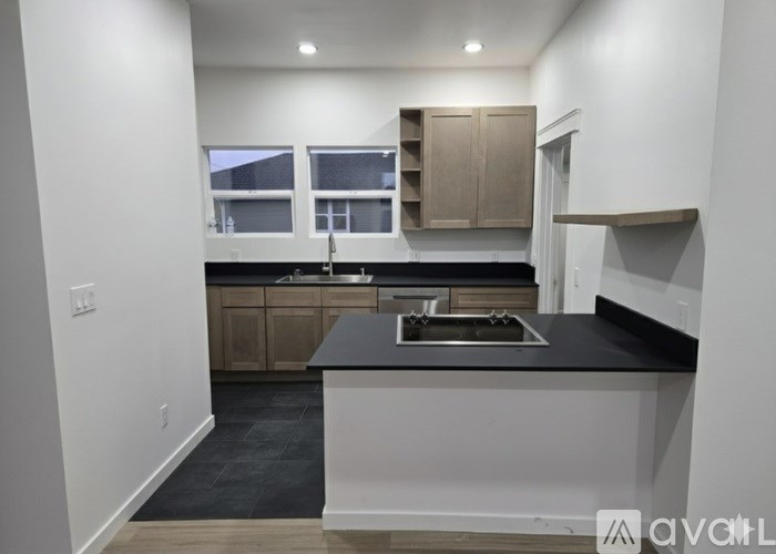 A kitchen with a black countertop and wooden cabinets.