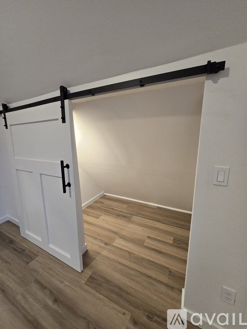 A white door with a black handle and a black bar above it.