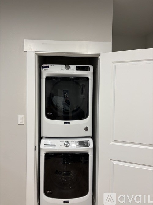 A white double oven built into a kitchen cabinet.