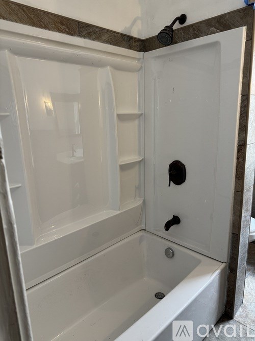 A white bathroom with a tub and shower.