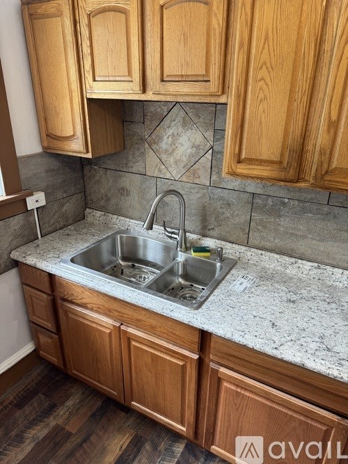 A kitchen with wooden cabinets and a granite countertop.