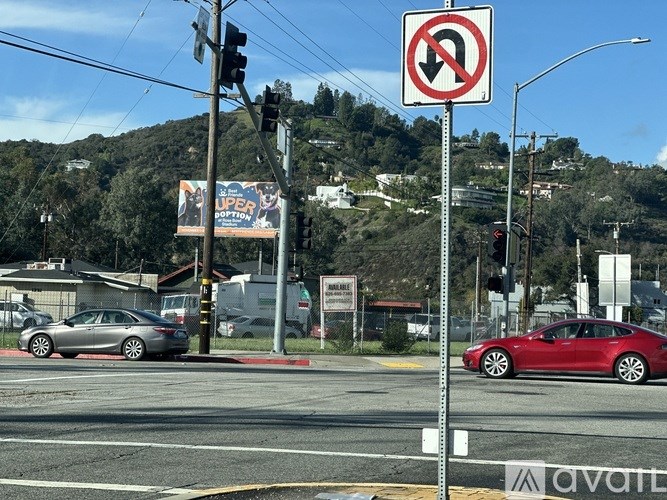 A no U-turn sign is posted at a street corner.