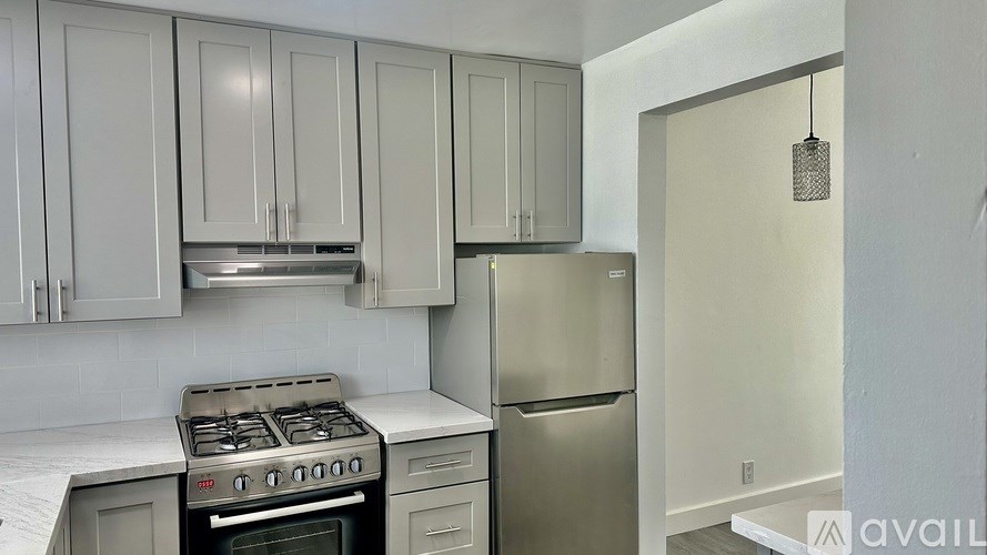 A kitchen with a stove, oven, and refrigerator.