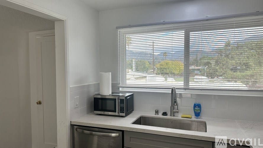 A kitchen with a microwave oven and a dishwasher.