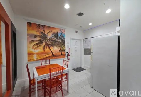 A dining area with a white table and red chairs.